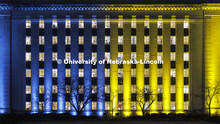 Love Library on the Nebraska’s City Campus is bathed in blue and yellow lights to show the world o
