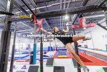 Leigh Jahnke flies through the air as she works her way across the apparatus using grabs called “w