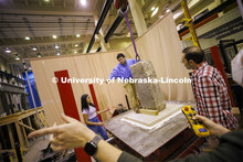 Students position a slab on a large shake table in Christine Wittich’s structures lab in Scott Eng