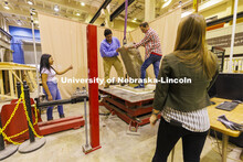 Students position a slab on a large shake table in Christine Wittich’s structures lab in Scott Eng