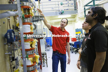 Hunter Flodman explains the equipment in the UO Lab with students Josiah Kolar and Aingaran Bala Ram