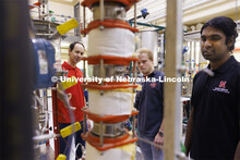 Aingaran Bala Raman, Ethan Yungdahl and Josiah Kolar examine a bioreactor in Hunter Flodman’s UO L