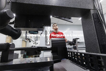 Garrett Beard sets up the laser for a titanium sample that will be laser treated in Craig Zuhlke’s