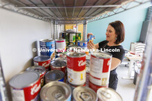 Emily Griffin Overocker, Fine and Performing Arts' Student Success Coordinator, arranges the shelves