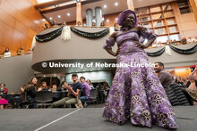 International students walk across the runway wearing cultural garments during the Global Glam fashi