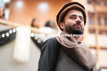 International students walk across the runway wearing cultural garments during the Global Glam fashi
