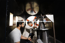 Wei Qiao demonstrates a wind turbine in the wind tunnel. College of Engineering photo shoot. March 3