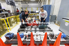 Jun Wang explains power trains in an electrical engineering lab. College of Engineering photo shoot.