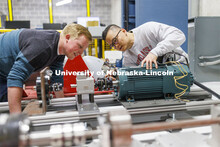 Jun Wang explains power trains in an electrical engineering lab. College of Engineering photo shoot.