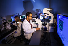 Students in Ryan Pedrigi and Ruiguo Yang’s lab work with microscopes, cell culture experimental eq