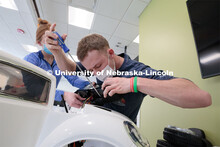 Ethan Bowles, a senior biological systems engineering major, makes an adjustment to the steering whe
