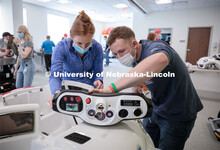 UNL engineering student Ethan Bowles, right, and UNMC physical therapy student Jaime Troester modify