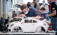 Ethan Bowles, a senior biological systems engineering major, makes an adjustment to the steering whe