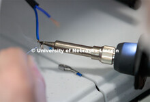 Ethan Bowles, a senior biological systems engineering major, makes an adjustment to the steering whe