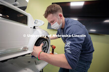 Ethan Bowles, a senior biological systems engineering major, makes an adjustment to the steering whe