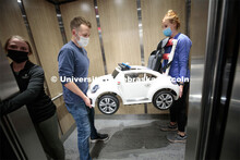 UNMC physical therapy student Chloe Williams, left, holds the elevator as UNL engineering student Et