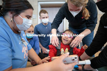 Four-year-old Dayana Torres is strapped into the new, battery-powered car that UNMC physical therapy