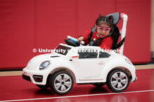 Four-year-old Dayana Torres enjoys the new, battery-powered car that UNL and UNMC students modified 