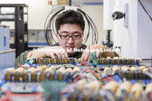 Zhenyu Meng works on a circuit board in Kuan Zhang’s IoT and AI lab. College of Engineering photo 