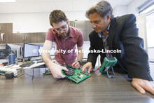 Matthew Boeding and Hamid Sherif test a board in Hamid Sherif’s Telecom lab. College of Engineerin