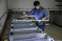 Dipendra Shrestha measures conductivity of a concrete block in Chungwook Sim’s Macrocell Corrosion