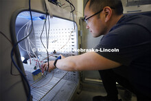 Bibo Zhong checks on concrete samples in a thermal chamber in Jinying Zhu’s lab. College of Engine