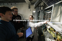 Students work out class assignments at the power panels in the PKI lighting lab. College of Engineer