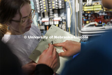 Students work out class assignments at the power panels in the PKI lighting lab. College of Engineer