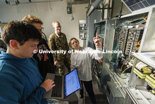 Students work out class assignments at the power panels in the PKI lighting lab. College of Engineer