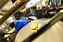 Students watch the changing shadows on a structure in a solar lighting setup in the lighting lab at 
