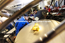 Students watch the changing shadows on a structure in a solar lighting setup in the lighting lab at 