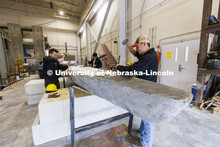 Braden Labenz, a junior from Columbus, Nebraska, works to remove the center form from the UNL concre