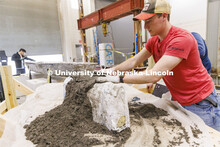 Braden Labenz, a junior from Columbus, Nebraska, works on a cross section as part of the concrete ca