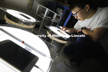 Yuan Feng checks the temperatures of bentonite samples in buckets in George Morcous’ lab.  Smart p