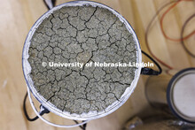 Yuan Feng checks the temperatures of bentonite samples in buckets in George Morcous’ lab.  Smart p