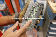 Dulitha Frederick shows a fractured sample in George Morcous’ lab. Smart phones are used to photog