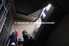 Board of Regents climb the stairs during a tour of the new College of Education and Human Sciences b