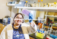 Sarah Altman checks a virus culture as she works in Shi-Hua Xiang’s lab in Morrison Hall. Altman, 