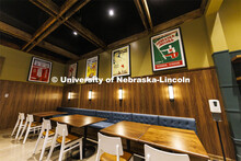Classic Husker football posters hang in an eating space within the new Scarlet Hotel. The Scarlet Ho