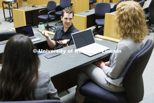 Students collaborating in a lecture hall in McCollum Hall. College of Law photo shoot. April 20, 202