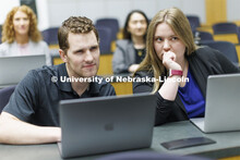 Students collaborating in a lecture hall in McCollum Hall. College of Law photo shoot. April 20, 202