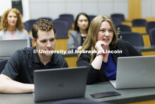 Students collaborating in a lecture hall in McCollum Hall. College of Law photo shoot. April 20, 202