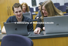 Students collaborating in a lecture hall in McCollum Hall. College of Law photo shoot. April 20, 202