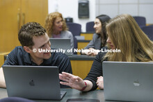 Students collaborating in a lecture hall in McCollum Hall. College of Law photo shoot. April 20, 202
