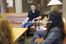 Students gathered in the hallway in McCollum Hall. College of Law photo shoot. April 20, 2022. 
