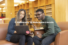 Two students compare laptop notes in the Schmid Law Library. College of Law photo shoot. April 20, 2