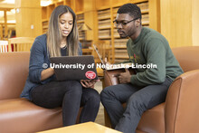 Two students compare laptop notes in the Schmid Law Library. College of Law photo shoot. April 20, 2