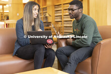 Two students compare laptop notes in the Schmid Law Library. College of Law photo shoot. April 20, 2