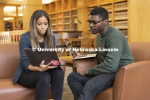 Two students compare laptop notes in the Schmid Law Library. College of Law photo shoot. April 20, 2