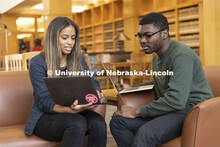 Two students compare laptop notes in the Schmid Law Library. College of Law photo shoot. April 20, 2
